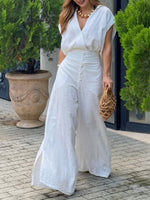 Two-piece Set Featuring A Stylish Cropped Linen-cotton Top And High-waisted Wide-leg Trousers.